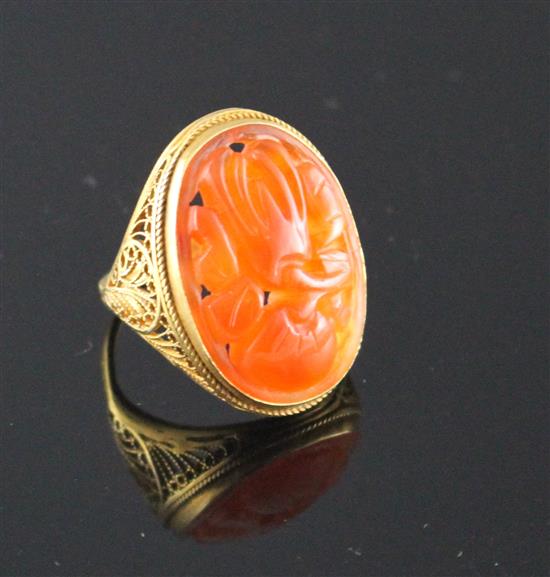 A 14k filigree yellow metal and orange chalcedony set dress ring, carved with fruit, size M, gross weight, 6 grams.